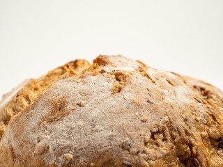 Dark bread on a white background. Round Bread with grains.
