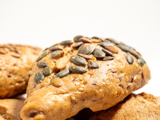 Dark buns on a white background. Bakery products with grains.