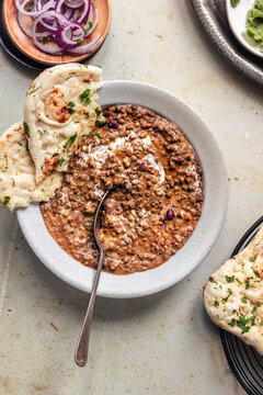 Bowl of Dal Makhani served with naan bread