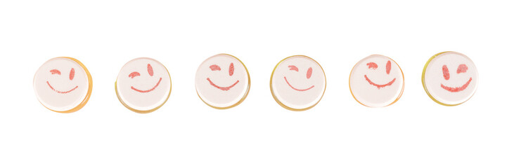Row of round funny sweets with smiling emoticons on them. Isolated png with transparency