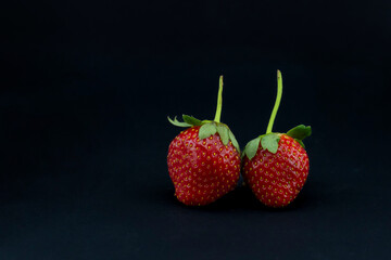 close-up strawberry fruit on black background