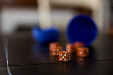 Orange game dice on wood table, dice game, game night