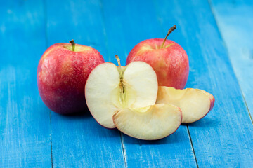 close-up apple on blue wooden background