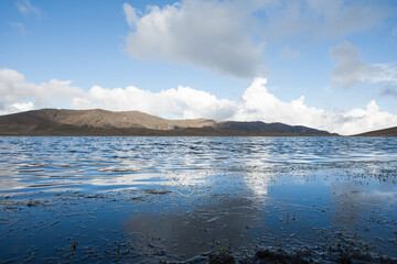 Lagoon high in the Andes of Peru, with mountains and blue sky in the background (Yauricocha Lagoon, Junin). Concept of nature.