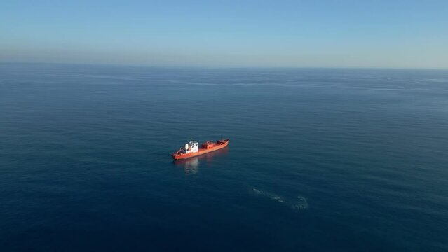 Aerial top down view of a 182 meters long oil chemical tanker ship. Supertanker loaded with full of oil, drifting in the sea. A petroleum tanker underway open sea. High quality 4k footage