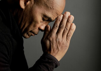 people praying to god at home on black background with people stock photo