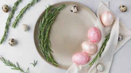 Easter still life, painted colorful eggs and quail eggs lying in a bowl on a gray background. close-up, mines space 