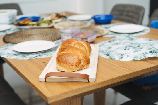 Challah bread on a table for Shabbat meal. Brioche. Homemade soft, fluffy white bread loaf.
