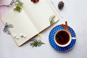 Obraz na płótnie Canvas Christmas mockup empty notepad with aesthetics coffee cup, doughnut, wireless earphones. New year resolution, planning, new start and list of goals concept