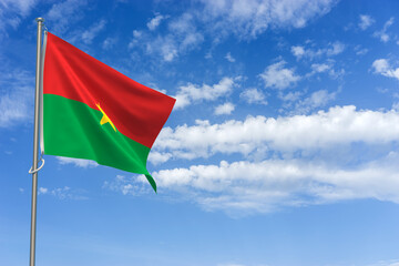 Burkina Faso Flag Over Blue Sky Background. 3D Illustration