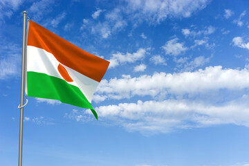 Republic of the Niger Flag Over Blue Sky Background. 3D Illustration