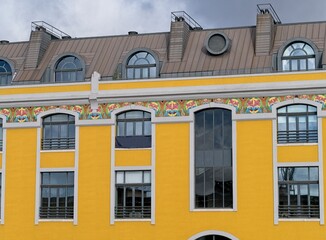 Egg yolk yellow building with decorative tiles in Lisbon, Portugal