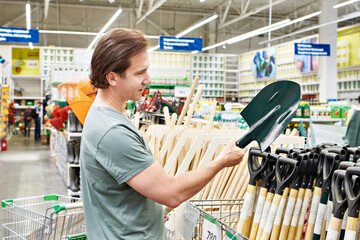Man buys a shovel in a store