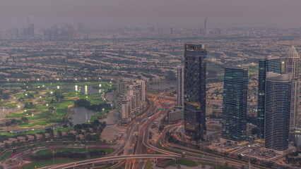 Naklejka na ściany i meble Big crossroad junction between JLT district and Dubai Marina intersected by Sheikh Zayed Road aerial day to night timelapse.