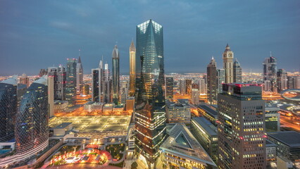 Panorama of futuristic skyscrapers in financial district business center in Dubai night to day timelapse
