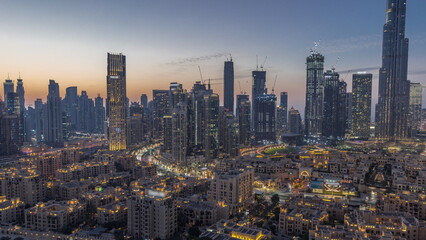 Obraz premium Dubai's business bay towers aerial day to night timelapse. Rooftop view of some skyscrapers