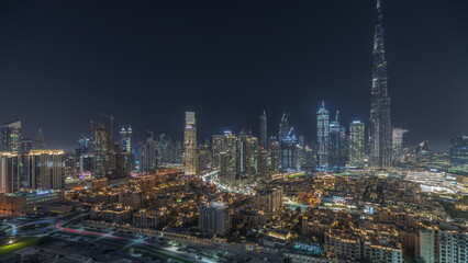 Fototapeta na wymiar Panorama showing Dubai Downtown and business bay night timelapse with tallest skyscraper and other towers