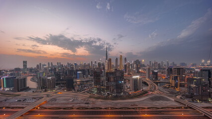 Panoramic skyline of Dubai with business bay and downtown district day to night timelapse.