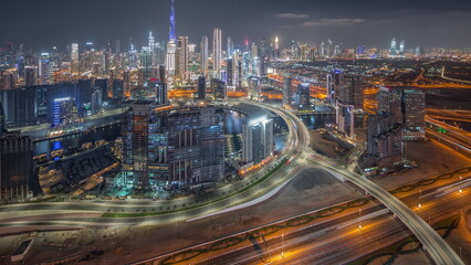 Panoramic skyline of Dubai with business bay and downtown district night timelapse.