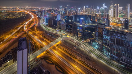 Obraz na płótnie Canvas Panorama showing skyline of Dubai with business bay and downtown district night timelapse.