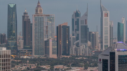 Rows of skyscrapers in financial district of Dubai aerial night to day timelapse.