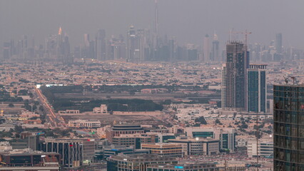 Fototapeta na wymiar Dubai Downtown skyline row of skyscrapers with tallset tower aerial day to night timelapse. UAE