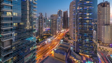 Panoramic view of the Dubai Marina and JBR area and the famous Ferris Wheel aerial day to night timelapse