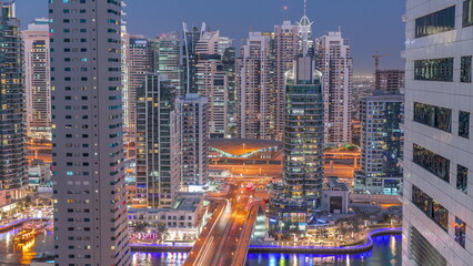 Aerial view on Dubai Marina skyscrapers and the most luxury yacht in harbor day to night timelapse, Dubai, United Arab Emirates