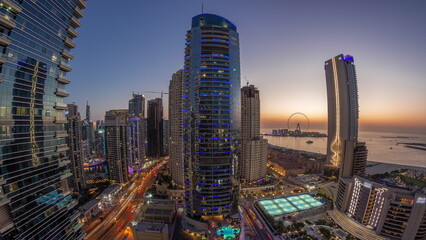 Panorama of the Dubai Marina and JBR area and the famous Ferris Wheel aerial day to night timelapse