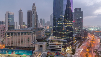Fototapeta na wymiar Dubai International Financial district aerial night to day timelapse. View of business office towers.