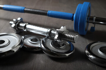 Naklejka na ściany i meble Dumbbell discs barbell for home sports on grey wooden background. Sport concept.