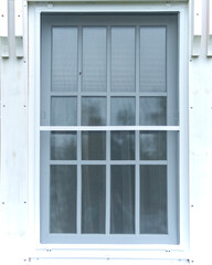mosquito net on the white window of the cottage