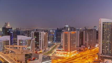 Fototapeta na wymiar Skyscrapers at the Business Bay in Dubai aerial day to night timelapse, United Arab Emirates