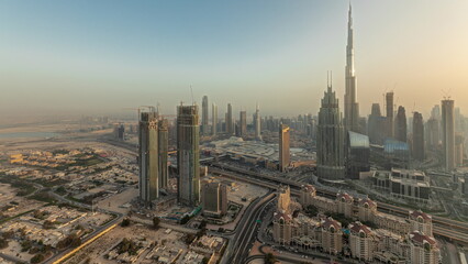 Fototapeta na wymiar Panorama showing aerial view of tallest towers in Dubai Downtown skyline and highway timelapse.