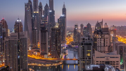 Obraz premium View of various skyscrapers in tallest recidential block in Dubai Marina aerial night to day timelapse