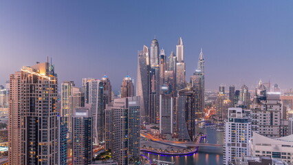 Fototapeta na wymiar View of various skyscrapers in tallest recidential block in Dubai Marina aerial day to night timelapse