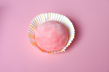 Closeup of pink japanese rice cake. Delicious mochi on pink background top view. Traditional Japanese dessert