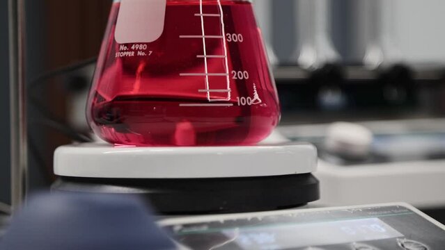 Chemical laboratory. Laboratory tableware with red chemical liquid