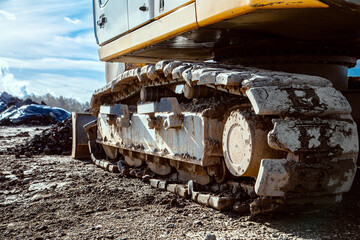 excavator metal track is kind of big wheel or tire of bulldozer and other working machines to drive on mud and rough terrain - obrazy, fototapety, plakaty