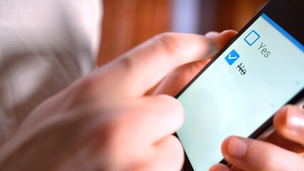 No checkbox vote button on the screen mobile phone. Hand push checkbox NO