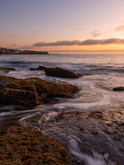 Fototapeta premium Water flowing between rocks on the coast.