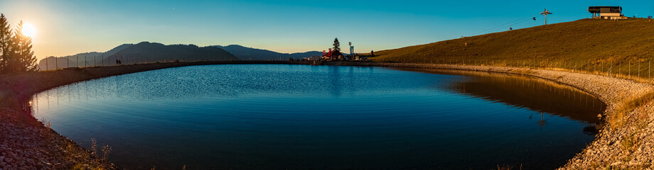 High resolution stitched panorama with reflections in a lake at the famous Wiedhag-Alpe, Bad Hindelang, Allgaeu, Bavaria, Germany