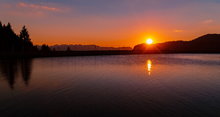 Obraz premium Beautiful alpine sunset view with reflections in a lake at the famous Wiedhag-Alpe, Bad Hindelang, Allgaeu, Bavaria, Germany