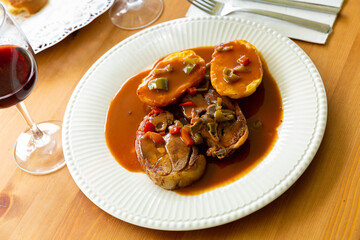 Roasted mutton served with vegetable gravy and baked potato