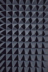 Black soundproof wall with acoustic dampening foam. Soundproof room in professional sound recording...