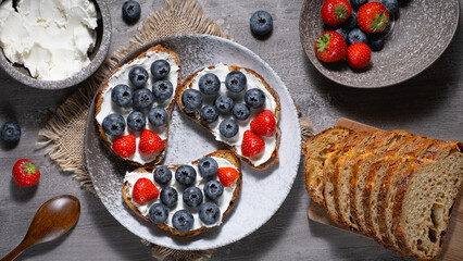 Fresh breakfast with blueberry, strawberry and ricotta rye sandwiches