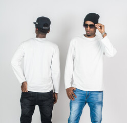 Two african man wearing white blank long sleeve shirt, doing a pose with one of them turning back and the other on the front side