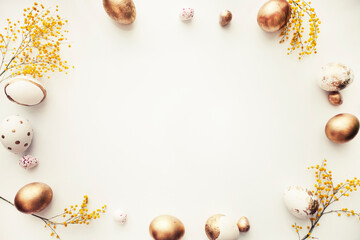 easter  holidays background with  golden eggs over white table