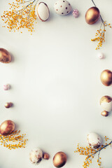 easter  holidays background with  golden eggs over white table
