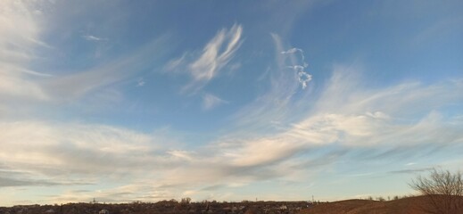 fleecy clouds in the blue sky